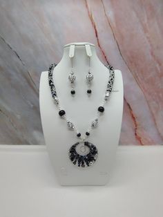 "Handmade and designed by me-one of a kind necklace set-spiral bead crochet necklace with a grey seed bead mix-23\" long-a 2 1/4\" x2 1/4\" hand crafted wire wrapped pendant-agste beads-various glass beads-metal beads-2 3/4\" long matching dangle earrings with kidney wires-lobster clasp-silver tone findings. This beautiful necklace set would be a great addition to your jewelry wardrobe! Orl give it as a unique present to someone special!" Bohemian Gray Beaded Jewelry, Elegant Beaded Spiral Jewelry, Gray Round Bead Jewelry For Parties, Gray Round Beads Jewelry For Party, Spiral Beaded Silver Jewelry, Silver Spiral Beaded Jewelry, Handmade Gray Round Bead Jewelry, Handmade Gray Round Beaded Jewelry, Handmade Gray Round Jewelry