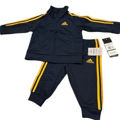 Adidas 2 Piece Jog Suit Navy Blue With Gold Trim Fitted Navy Sets For Spring, Casual Navy Sets For Spring, Navy Cotton Sets For Spring, Sporty Long Sleeve Playtime Sets, Fitted Blue Playtime Sets, Blue Casual Fitted Sets, Casual Blue Fitted Sets, Blue Fitted Casual Sets, Adidas Sports Set With Long Sleeve