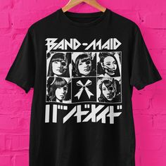 Band-Maid skull faces graphic t shirt. Makes a great gift for J-pop fans, Band-Maid rock fans.  Bella+Canvas 3001 * 100% Air Lume combed and ring spun cotton (fiber content may vary for different colors) * Light fabric (4.2 oz/yd² (142 g/m * Retail fit * Tear away label * Runs true to size With side seams Located along the sides, they help hold the garment's shape longer and give it structural support Shoulder tape Twill tape covers the shoulder seams to stabilize the back of the garment and pre Halloween Concert T-shirt With Screen Print, Black Band Merch T-shirt With Logo, Band Merch T-shirt For Concert, Pop Culture Graphic Print T-shirt For Concert, Band Merch T-shirt With Graphic Print For Fans, Band Merch Graphic Print T-shirt For Fans, Black Band Logo T-shirt For Alternative Fashion, Alternative Band Logo Tops For Music Festivals, Alternative Tops With Band Logo For Music Festivals