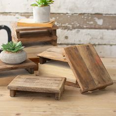 small wooden tables and stools with succulent plants on them