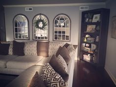 a living room filled with furniture and windows