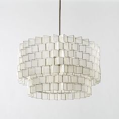 a white chandelier hanging from a ceiling