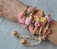 a woman's arm with several bracelets made from crochet and beads