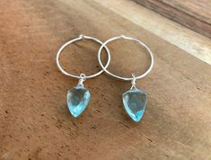 Dainty little aquamarine faceted crystal gemstone hoop earrings in 20mm sterling silver or 14k gold filled hoops. Option for gold plated and silver plated are less expensive. Please see drop down. Perfect for March birthdays! 💙Aquamarine, a stone of serenity, calms and soothes with it's lovely blue/green color and evokes the calm of the water with it's given name, which is interpreted at 'water of the sea' derived from Latin. A stone that celebrates the sea goddess of ancient times, it was carr Sterling Silver Huggie Birthstone Jewelry, Sterling Silver Birthstone Huggie Jewelry, Sterling Silver Hoop Crystal Earrings For Gift, Silver Gemstone Small Hoop Earrings, Sterling Silver Gemstone Hoop Earrings, Silver Gemstone Hoop Earrings, Silver Small Hoop Earrings With Gemstone, Blue Sterling Silver Hoop Jewelry, Blue Hoop Sterling Silver Jewelry