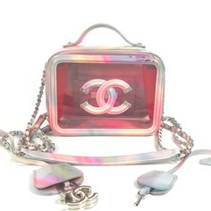 This Is An Extremely Rare Authentic Chanel Pvc Patent Lambskin Small Cc Vanity Case In Pink Multicolor. This Chic Stylish Crossbody Bag Is Crafted Of Delightful Multicolor Patent Leather With Pink Tinted Transparent Panels. It Features A Top Handle, Patent Leather Threaded Chain Link Shoulder Straps With Matching Patent Leather Shoulder Pad, And A Large Chanel Cc Stitched Logo With Silver Tips On The Front. Base Length: 6.50 In Height: 5.00 In Width: 3.25 In Drop: 1.00 In Drop: 23.7 Condition: Good Condition. Minor Signs Of Wear Present, Scratches, Scuffs, Color Transfer, Pen Marks. Please Refer To All Photos As They Are Part Of The Description. We Ship Daily 100% Positive Feedb Handbag Model, Thread Chains, Zipper Parts, Small Vanity, Vanity Bag, Vanity Case, Leather Thread, Handbag Wallet, Wallet Accessories