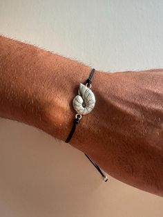 A minimal Sea Shell bracelet that is made from a unique Cowrie Shell from brass and is passed through an adjustable black cord, that creates the perfect color combination between these materials. Choose between four different dimensions. You can wear them together as set or separetely. Find them only at Christina Christi Store. 👉 My Mens Bracelets Collection: https://etsy.me/2UunKla 👉 Express Shipping: https://etsy.me/3ikUnOM MATERIALS - Metal Sea Shell (Brass). - Balck Cord. DIMENSIONS - You Cowrie Shell Bracelet, Seashell Bracelet, Bracelets Collection, Mens Bracelets, Jewelry Mens, Seashell Jewelry, Bracelet Men, Shell Bracelet, Shell Jewelry