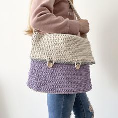 - Crochet messenger bag handmade in the UK using 100% cotton.  - Our bags are both durable and washable at 30 degrees, purposefully designed to be a long lasting new staple of any wardrobe.  - The simple and unique style is perfect for anyone of any age, suiting most styles and occasions. - The satchel style bag is fastened with two wooden buttons on the front which say "handmade with love".  - Either side of the strap on the bag are small wooden buttons, which are perfect for attaching bag char Crochet Satchel Bag, Crochet Satchel, Cute Messenger Bag, Crochet Messenger Bag, Cute Messenger Bags, Crochet Shoulder Bag, Purple Bag, Bag Charms, Bag Cute