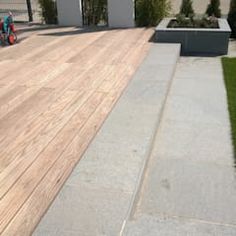 a skateboarder is riding down a wooden ramp in front of a house with grass