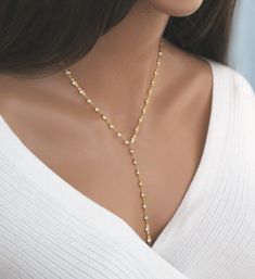 "Elevate your style with our \"Sparkling Elegant CZ Lariat,\" a dazzling piece that seamlessly combines timeless charm with modern sophistication. This necklace is designed for those who appreciate the brilliance of cubic zirconia, exuding a radiance that rivals the finest gemstones. ✦ Gold or Silver Cz Bezel Chain   ✦ 4mm Sparkling Cz's ✦ Handmade to order ✦ To order an extension: https://www.etsy.com/listing/233998668 WHY YOU'LL LOVE IT * Because handmade = made with love, care, and thought. * Ethically Sourced * Comes beautifully gift boxed * Crafted with care from sunny South Florida. ♡ HAPPINESS GUARANTEE: We stand by our jewelry and want you to love it too! GIFTS All orders are sent packaged in a jewelry box - ready to be gifted! Upon request, we can also include a note card with you Wedding Gold Diamond Lariat Necklace, Lariat Bridal Necklace For Party, Gold Cubic Zirconia Lariat Backdrop Necklace, Formal Crystal Lariat Jewelry, Gold Crystal Lariat Necklace, Adjustable Diamond Lariat Jewelry, Adjustable Sparkling Fine Jewelry, Adjustable Lariat Diamond Jewelry, Gold Lariat Necklace With Diamond Accents For Wedding