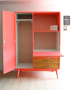 an orange and pink cabinet with two drawers