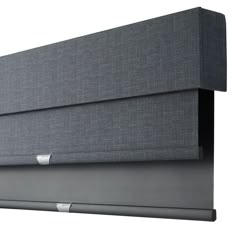 a close up view of the back side of a gray headboard with silver trim