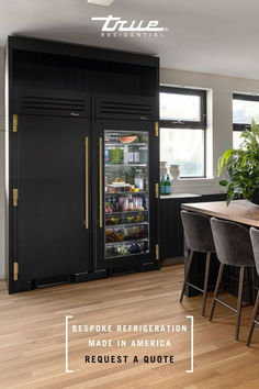 a refrigerator with its door open in the middle of a kitchen next to a dining room table and chairs