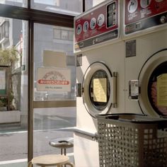 a washer and dryer sitting next to each other in front of a window