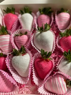 a box filled with lots of pink and white chocolate covered strawberries