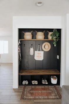 the entryway is decorated with baskets, pots and other things to put on it