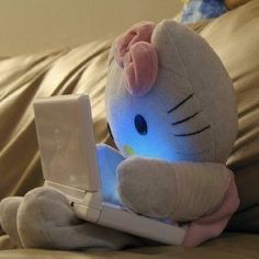 a hello kitty stuffed animal sitting on top of a bed