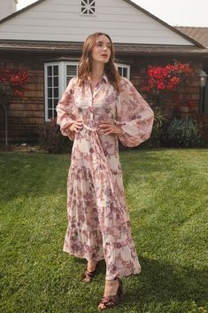 This floral chiffon maxi dress is sophisticated yet effortless with its high collar, button-up design paired with bishop sleeves, tiered skirt, and a slim matching sash. Crafted with a soft, airy fabric that drapes beautifully, this piece is a timeless addition to any wardrobe. Machine wash cold, gentle cycle, and hang dry. Spring Daywear Maxi Dress With Tiered Skirt, Tiered Skirt Maxi Dress For Daywear In Spring, Tiered Maxi Dress With Floral Print For Daywear, Feminine Tiered Skirt Maxi Dress For Daywear, Floral Print Tiered Maxi Dress For Daywear, Feminine Tiered Maxi Dress For Daywear, Daywear Floral Print Tiered Maxi Dress, Tiered Floral Print Maxi Dress For Daywear, Floral Chiffon Maxi Dress