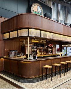 an empty bar with stools in front of it