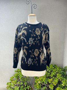 "Vintage Cristina's pullover glam sweater black knit with metallic silver gold floral Sz M. Made in Taiwan good condition. Made of nylon acrylic metallic blend.  Measurements no stretch included  Shoulders 21\" Sleeves 19\" Bust 40\" Waist 34\" Hips 30\" Length 25\"" Elegant Gold Winter Sweater, Black Long Sleeve Sweater With Sequins, Black Vintage Luxury Sweater, Black Beaded Sweater, Women’s Silver Sweaters, Pullover Sweater Women, Black Knit, Women Pullover, Black Sweaters