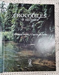 the book crocodiles of australia contains pictures of water, trees and other animals in its natural habitat