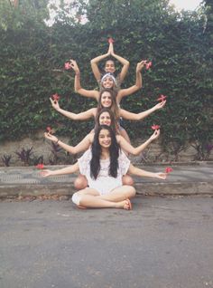 a group of women sitting on the ground doing yoga