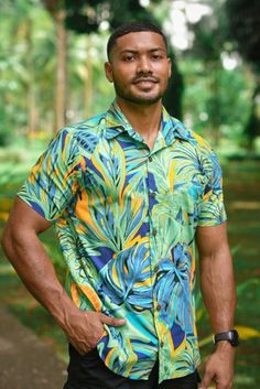 Bula Means Hello in Fijian. The Bula/Aloha shirt, made in Fiji, is a true embodiment of island paradise and vibrant style. Crafted with meticulous attention to detail, this shirt showcases the rich cultural heritage of Fiji while offering a unique and modern twist. The first striking feature of this Bula/Aloha shirt is its vibrant prints. We take inspiration from Fiji's lush tropical landscapes, beautiful beaches and ocean, breathtaking sunsets, and vibrant flora and fauna to create mesmerising patterns. These prints are an eclectic mix of bold and vivid colors, reflecting the vibrancy and liveliness of the Fijian culture.  Made with 100% cotton fabric, this shirt ensures comfort and breathability in tropical climates. The high-quality cotton fabric allows air to circulate, keeping the wea Green Floral Print Hawaiian Shirt For Beach Season, Green Floral Hawaiian Shirt For Beach Season, Tropical Beach Shirt With Hibiscus Print, Tropical Beach Camp Shirt With Tropical Print, Tropical Print Camp Shirt For Beach, Beach Season Green Shirt With Floral Print, Tropical Camp Shirt For Beach, Beach Season Green Floral Print Shirt, Green Floral Print Shirt For Beach Season