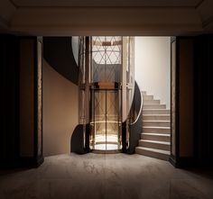 an open door leading to a staircase in a room with marble floors and black walls