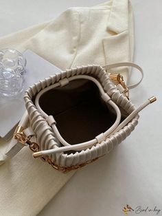 BirdinBag - Compact Pleated PU Mini Bucket Bag with Chain Embellishment Chic Rectangular Bucket Bag As Fashion Accessory, Beige Bucket Bag With Chain Strap, Beige Bucket Shoulder Bag With Chain Strap, Beige Shoulder Bucket Bag With Chain Strap, Gold Bucket Bag With Chain Strap, Rectangular Bucket Bag With Chain Strap, Trendy Cream Bag With Chain Strap, Elegant Beige Bag With Chain Detail, Bucket Shoulder Bag With Chain Strap