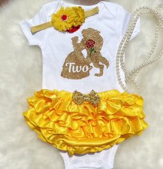 This listing is for Baby girl's Belle theme 2nd Birthday outfit .  Includes  1.Bodysuit/ T-shirt  2.Bloomerskirt  3.Headband  Shoes sold separately  Name can be added on the bodysuit. Please leave a note in the note to seller box upon checkout for personalization. All outfits are made to Order and standard PROCESSING time is 2 weeks.  *Processing time DOES NOT INCLUDE SHIPPING TIME. U.S. SHIPPING is based on the method of shipping you choose at checkout in the drop down menu: Standard (first cla Yellow Short Sleeve Party Set, Belle Outfit, Outfit Yellow, 2nd Birthday Outfit, Disney Princess Birthday, July Baby, American Baby, Girl 2nd Birthday, Gold Outfit