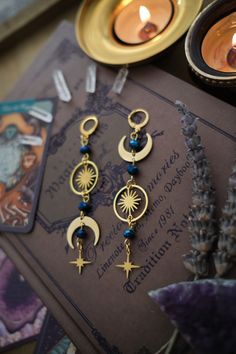 * Stunning mismatched statement earrings 🖤 These stainless steel Moon and Stars earrings will give your outfit an instant witchy, mystical touch. * Stainless steel! * The total length of the earrings is approximately 9 cm (aprox 3.5 inches), hook included.  * They come in a pretty little burlap pouch 🖤 *Matching necklace available here: https://www.etsy.com/listing/1447894232/witchy-choker-necklace-witchy-silver Mystical Metal Earrings With Moon Charm, Celestial Metal Earrings With Moon Charm, Celestial Moon Charm Metal Earrings, Metal Moon Charm Earrings In Celestial Style, Celestial Moon-shaped Pierced Cartilage Earrings, Celestial Crescent Cartilage Earrings, Celestial Cartilage Earrings With Moon Charm As Gift, Celestial Moon Shaped Pierced Cartilage Earrings, Mystical Metal Pierced Earrings