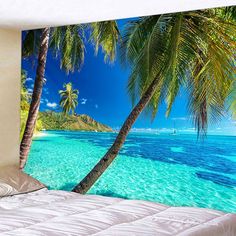 a tropical beach scene with blue water and palm trees