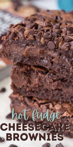 two chocolate brownies stacked on top of each other with the words hot fudge cheesecake above them