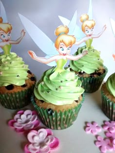 cupcakes decorated with green frosting and tinker fairy