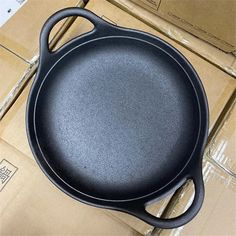 an empty cast iron skillet sitting on top of boxes