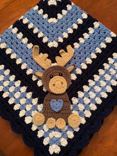 a crocheted blanket with a moose on it