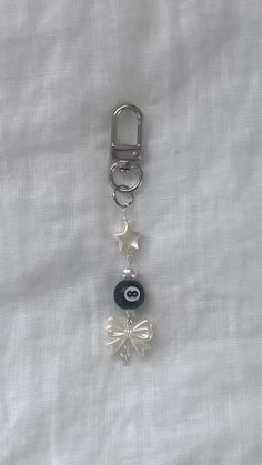 a keychain with an evil eye charm attached to it's side on a white sheet