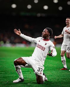 two soccer players are on the field during a game