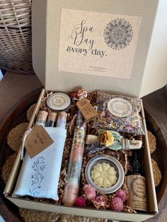 a box filled with lots of different items sitting on top of a wooden table next to a wicker basket