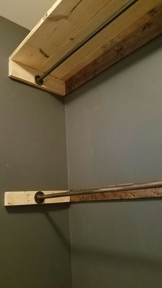 an unfinished wooden shelf in a bathroom next to a toilet