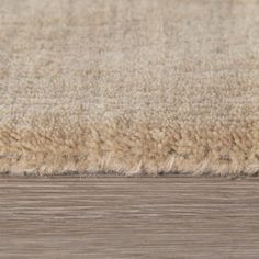 an area rug that has been placed on the floor and is beige with brown tones