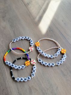 three bracelets with words written on them sitting on a table next to each other