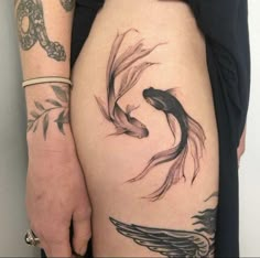 a woman's thigh with two goldfish tattoos on it