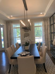 a dining room table with chairs and a chandelier