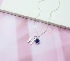 A highly personalised necklace with a genuine blue Sapphire gemstone birthstone charm and a 925 Sterling Silver letter threaded onto delicate 925 Sterling Silver chain. Sapphire is the traditional September Birthstone. Delicate, dainty and pretty, this makes the perfect favourite everyday necklace, and a lovely personalised gift for anyone with a September birthday or who simply loves Sapphire. - All parts solid 925 Sterling Silver - Birthstone charm features a genuine natural Sapphire gemstone Personalized Blue Birthstone Necklace As Gift, Birthstone Initial Pendant Charm Necklace As Gift For Her, Blue Sterling Silver Birthstone Necklace For Gifts, Blue Sterling Silver Birthstone Necklace As Gift, Personalized Blue Sterling Silver Necklace, Sterling Silver Initial Pendant Charm Necklace With Gemstone, Silver Initial Necklace With Birthstone For Gift, Sterling Silver Initial Necklace With Birthstone For Birthday, Sterling Silver Birthday Initial Necklace With Birthstone