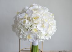 a bouquet of white flowers sitting on top of a table