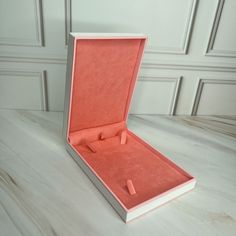 an open pink box on a white table