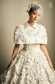 a woman wearing a white dress and veil