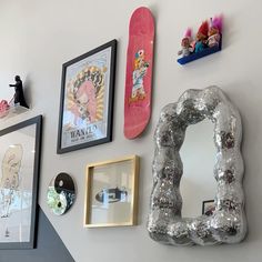 the wall is covered with skateboards and pictures