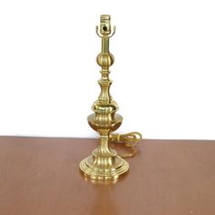 a golden candle holder on a wooden table