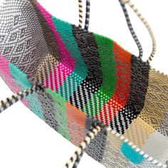 a multicolored woven bag hanging from a string